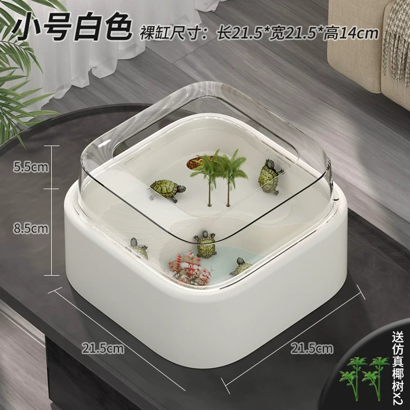 Small white turtle tank with clear lid, artificial palm decor, and mini turtles inside.